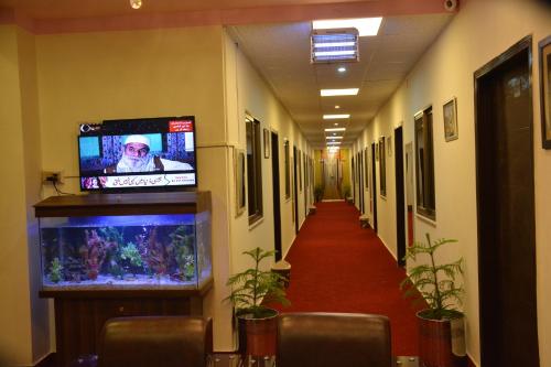 a hallway in a hospital with a fish tank at Hotel Red Line in Islamabad