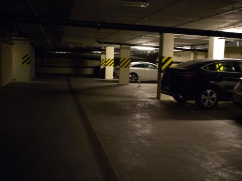 a parking lot with cars parked in a parking garage at Dariusz Apartament PREMIUM Jurata z garażem in Jurata