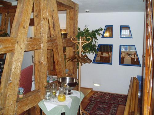 a dining room with a table and a ladder at Insel-Hof Reichenau Hotel-garni in Reichenau