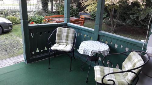 two chairs and a table on a porch at Szalay Villa in Veszprém