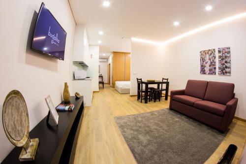 a living room with a couch and a table at Bugalha My Loft Douro 3 in Peso da Régua