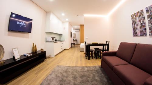 a living room with a couch and a table at Bugalha My Loft Douro 3 in Peso da Régua