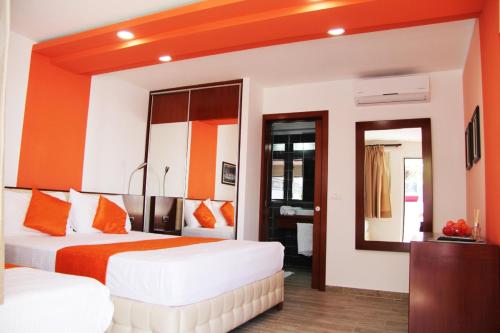 a hotel room with two beds and a mirror at Hotel ANTAG in Shëngjin