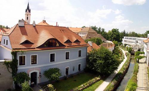 a large white building with a red roof at Penzion a restaurace U Míšků in Třeboň