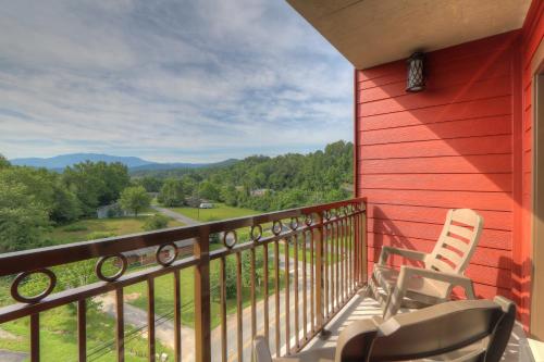 a balcony with two chairs and a view of the mountains at Country Cascades Waterpark Resort in Pigeon Forge