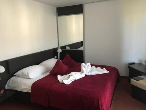 a hotel room with a bed with a towel on it at Pensiunea Domnika in Dej