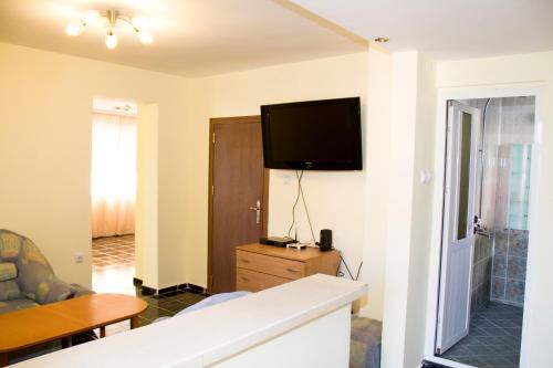 a living room with a flat screen tv on the wall at ,,Дироси'' in Sveti Vlas