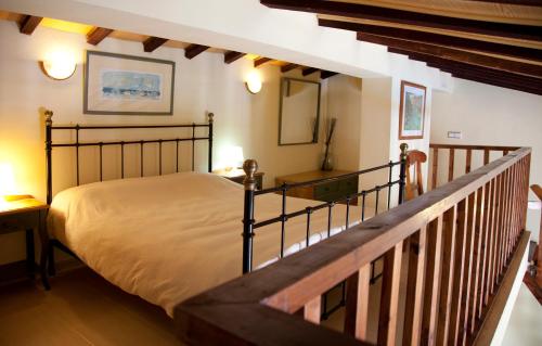 a bedroom with a large bed and a staircase at Apartamentos Carabela II in Paguera