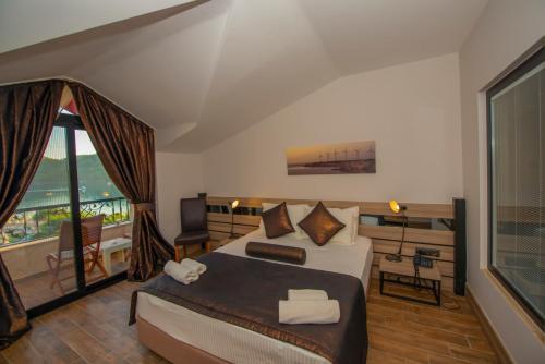 a hotel room with a bed and a balcony at S3 Seahorse Beach Club in Oludeniz
