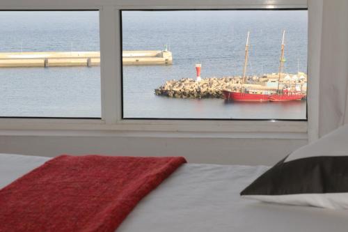 a bedroom with a window with a view of the ocean at Casa Miramar in Gran Tarajal