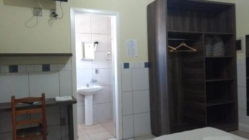 a bathroom with a sink and a toilet and a shower at Ville House Hotel Canoas in Canoas