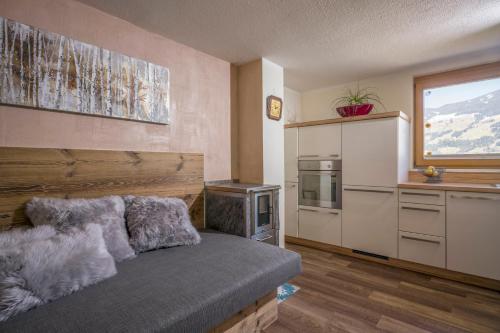 a kitchen with a couch in a room at Apartments Gondelspaß in Fügen
