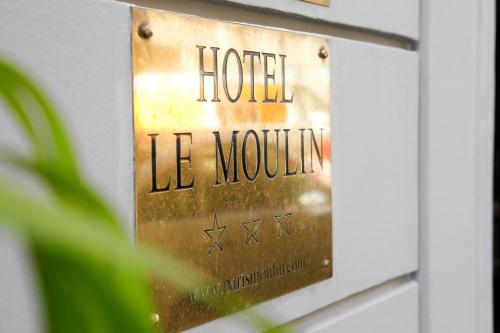 a sign on a wall in front of a door at Hotel Moulin Plaza in Paris