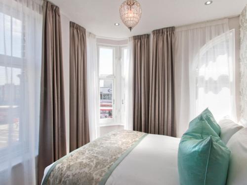 a bedroom with a bed and a large window at W12 Rooms in London