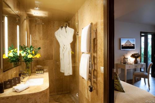 a bathroom with a dress hanging on a wall at B Montmartre in Paris