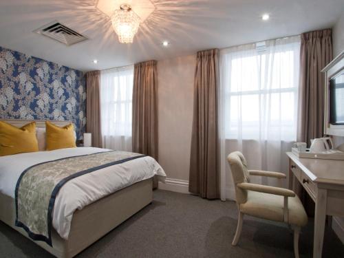a bedroom with a bed and a desk and a chair at W12 Rooms in London