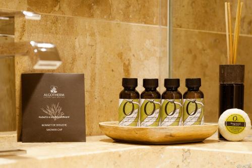 a group of four bottles of essential oils on a counter at B Montmartre in Paris