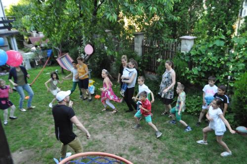 a group of children playing in a yard with balloons at Family Hotel Bansko Sofia in Sofia