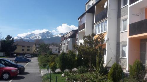 a view of a building with mountains in the background at Apartmán Tatry-Nová Lesná in Nová Lesná