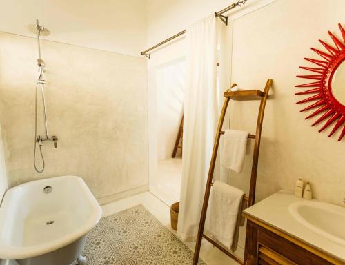 a white bathroom with a sink and a shower at Rukgala Retreat in Digana