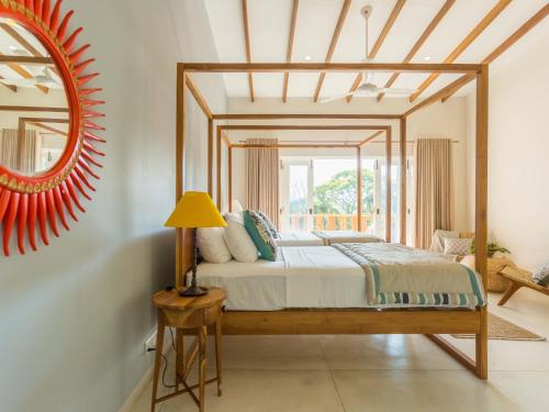 a bedroom with a bed and a mirror at Rukgala Retreat in Digana