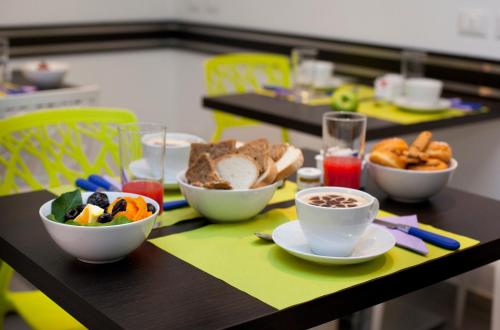 a table with bowls of food and cups of coffee at Sorrento Flats in Sorrento