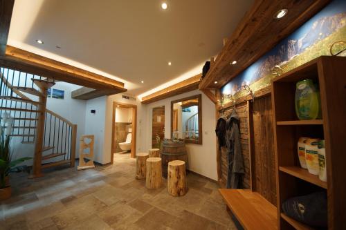 a room with a staircase and aoyer with wooden beams at Kaiserappartements-Marie in Ellmau