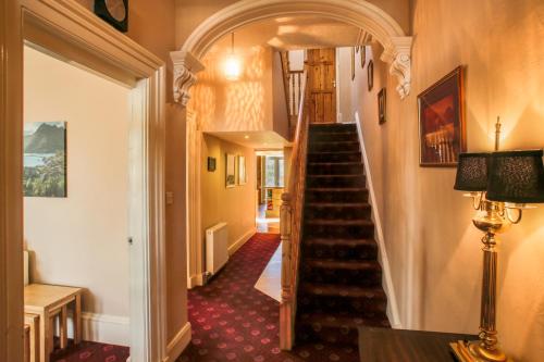 a hallway with a staircase in a house at Ness House in Inverness