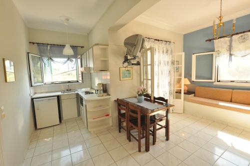 a kitchen with a table and a dining room at Elena Apartments Corfu in Acharavi