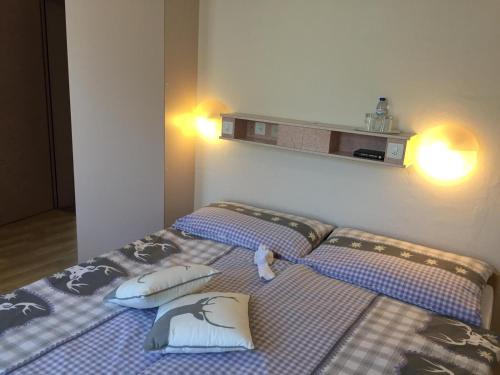 a bedroom with two beds with pillows on them at Hotel Restaurant Escher in Leukerbad