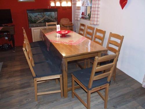 a dining room table and chairs with a red bowl on it at Schluchthäusl in Lunzenau