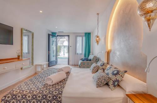 a bedroom with a large bed and a large window at Hotel & Spa La Residencia Puerto in Tarifa