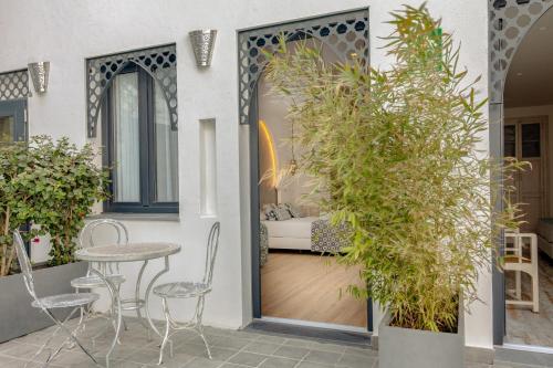 a patio with a table and chairs next to a door at La Residencia Puerto Hotel & Spa in Tarifa