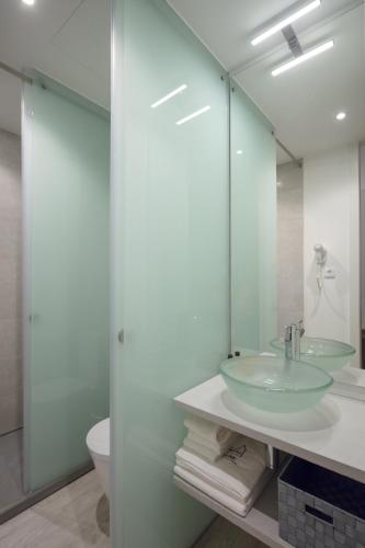 a bathroom with a sink and a mirror at Porto Deluxe Suites in Porto