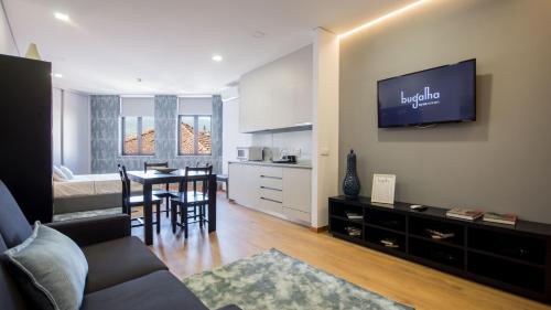 a living room with a couch and a dining room at Bugalha My Loft Douro 4 in Peso da Régua