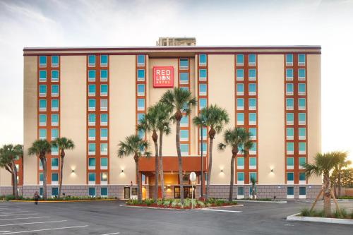 a rendering of a hotel with palm trees in front at Red Lion Hotel Orlando Lake Buena Vista South- Near Disney in Kissimmee
