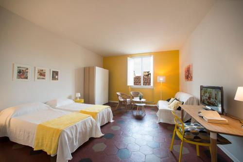 a bedroom with a bed and a desk and a tv at Florence Oasis in Florence