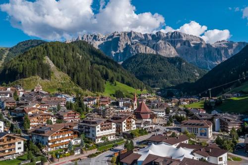 an aerial view of a town in the mountains at Astor Suites B&B in Selva di Val Gardena