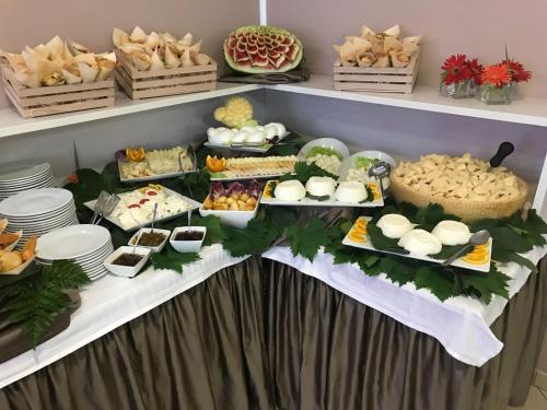 a buffet of food on a table with plates at Bikini Hotel in Vieste