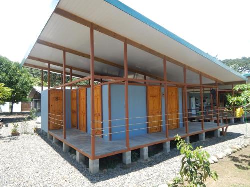 a house under construction with wooden doors and windows at Karandi Hostel in Uvita