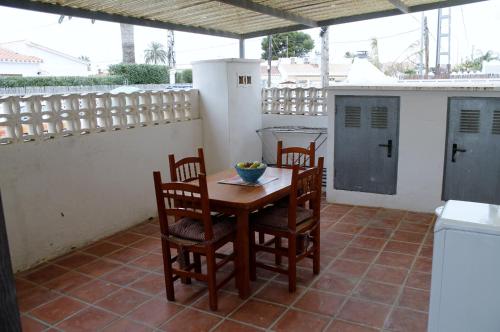 a wooden table and chairs on a patio at Bungalow in Denia