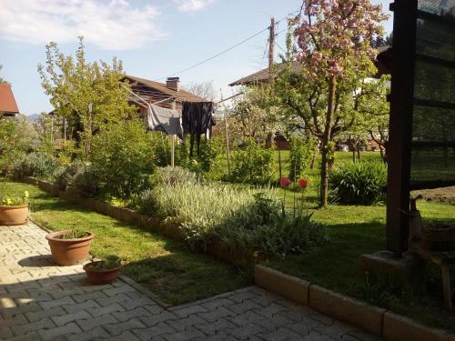 un jardín con plantas y una casa en APARTMA SONČEK en Ljubno