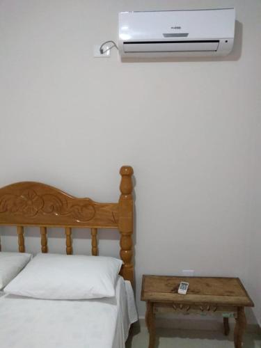 a bedroom with a bed and a air conditioner on the wall at Pousada Mandala in Bonito