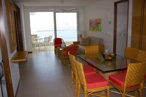 a living room with a glass table and chairs at Hotel Irotama Reservado in Santa Marta
