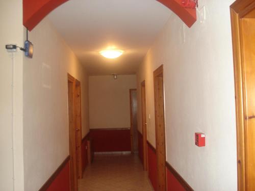 a hallway of an empty room with a ceiling at Apolis hotel in Mouzákion