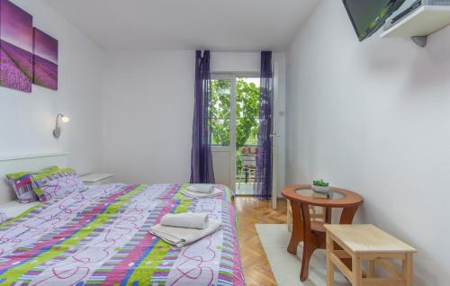 a bedroom with a bed and a small table at Apartment Complex Sauko in Poreč