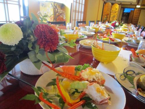 a long table with plates of food on it at Ryokan Taishoro in Sakurai