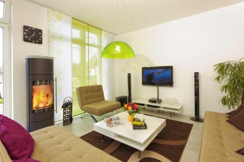 a living room with a couch and a fireplace at Lotsenstieg 15 in Ostseebad Karlshagen