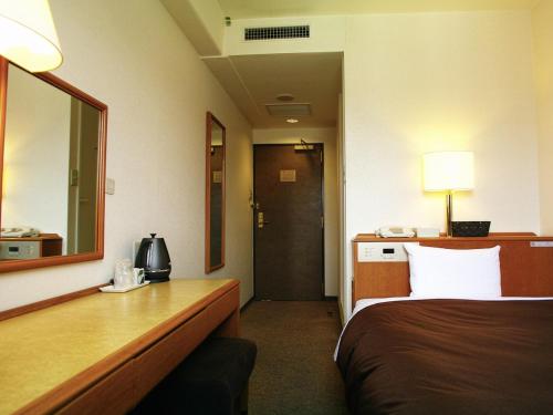 Postel nebo postele na pokoji v ubytování Tourist Hotel Hitachi