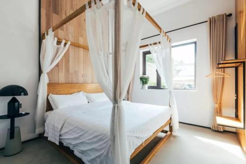 a bedroom with a canopy bed and a window at Simatai No.19 Villa in Miyun